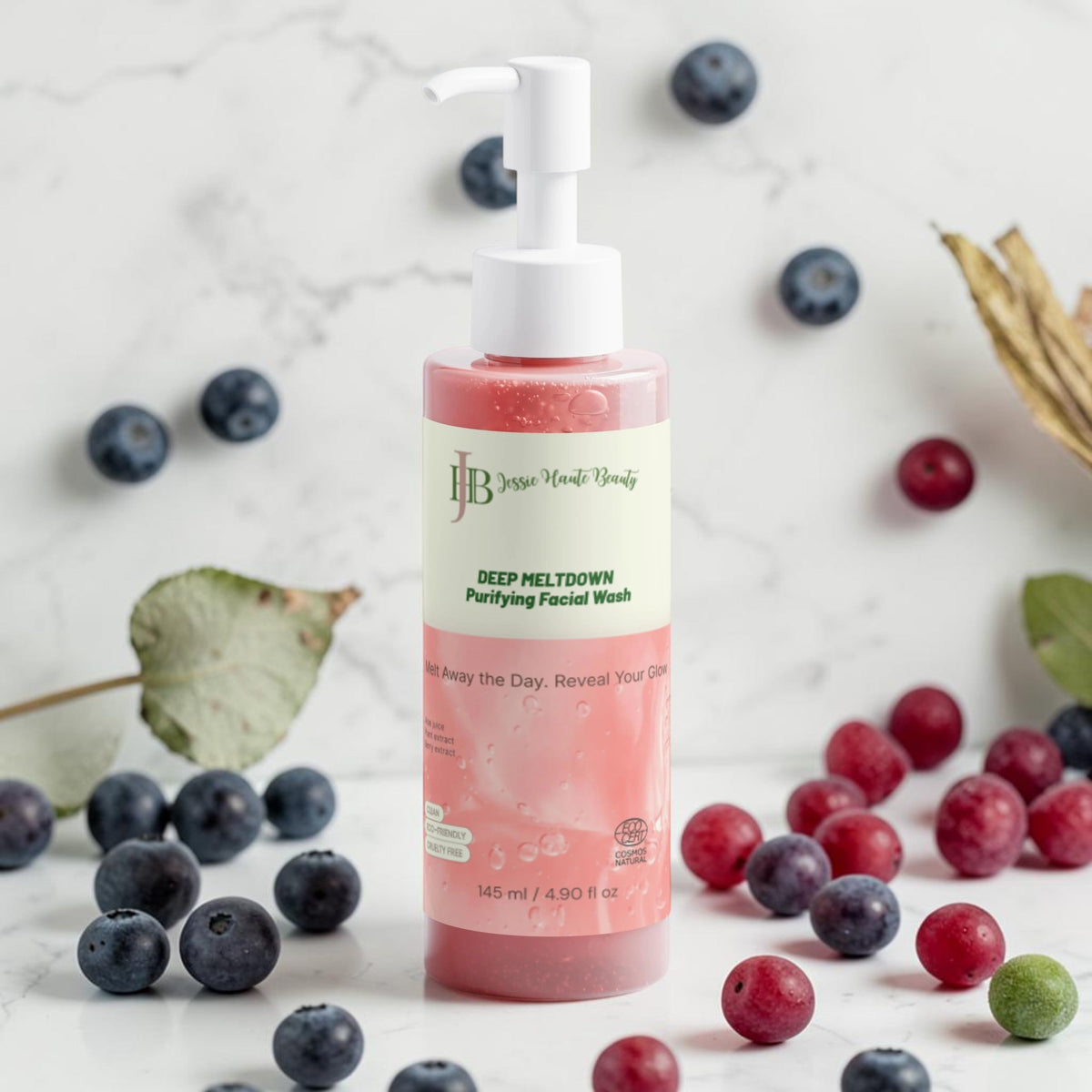 Facial wash bottle with berries on a marble background