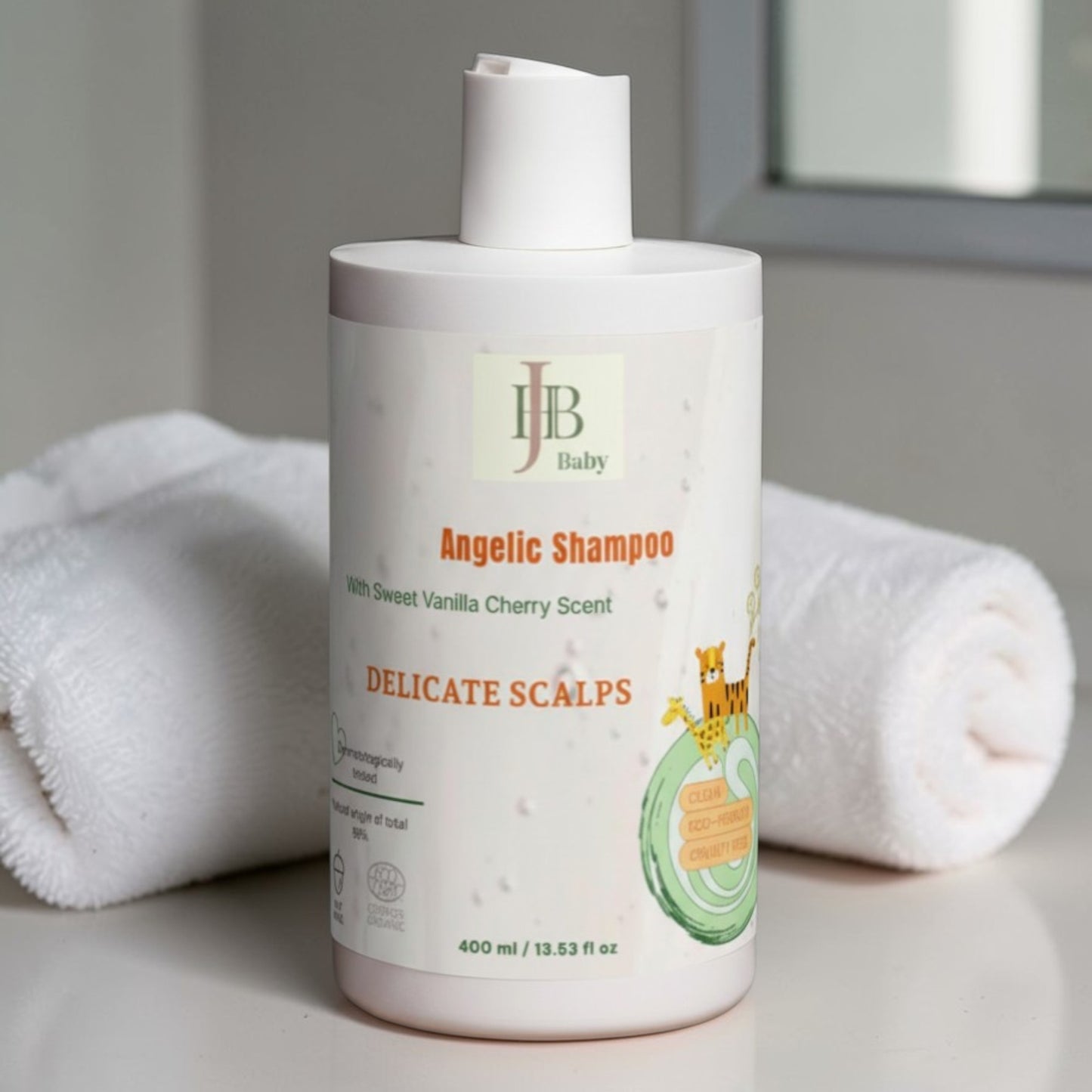 JH B Baby Angelic Shampoo bottle with a towel in the background