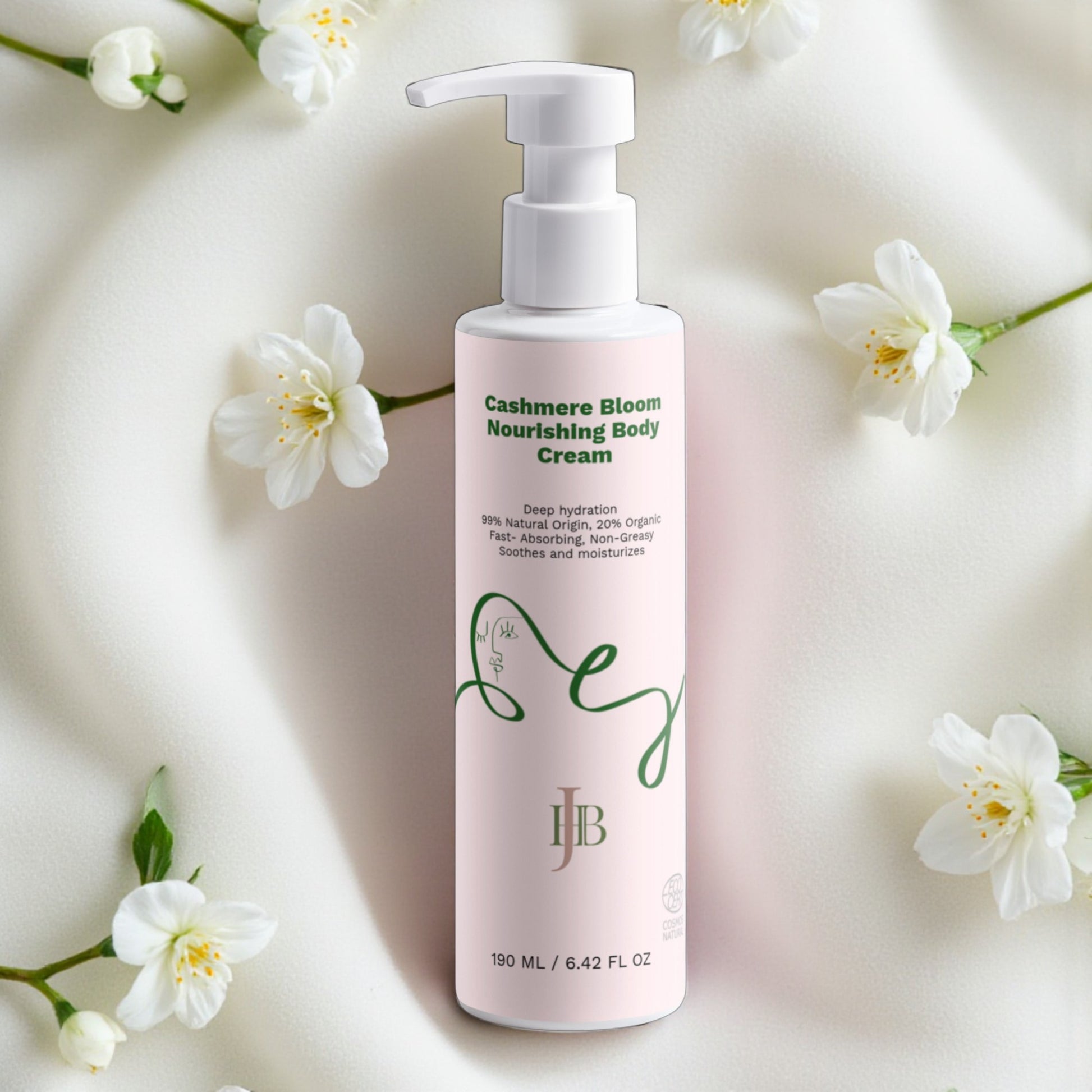 Pink bottle of Cashmere Bloom Nourishing Body Cream with white flowers on a light background