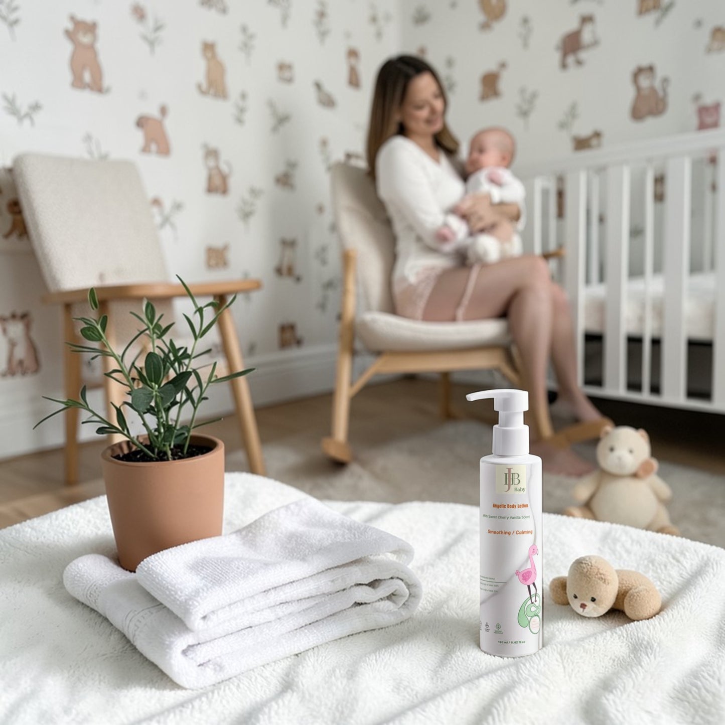 Baby care products on a blanket with a woman holding a baby in the background