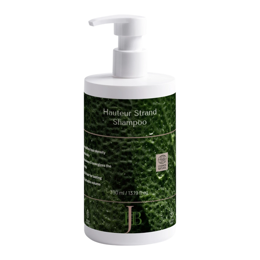 Shampoo bottle with green label and white pump on a white background
