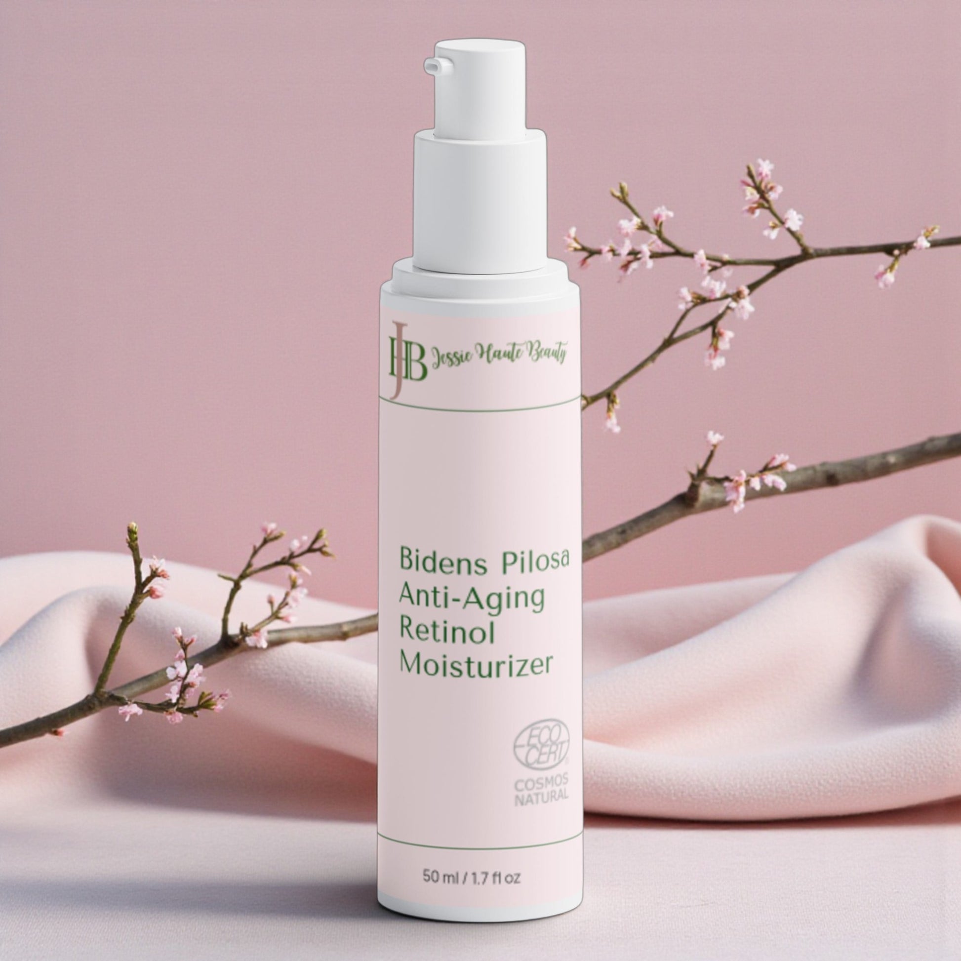 Bottle of Bidens Pilosa Anti-Aging Retinol Moisturizer with cherry blossom branches on a pink background