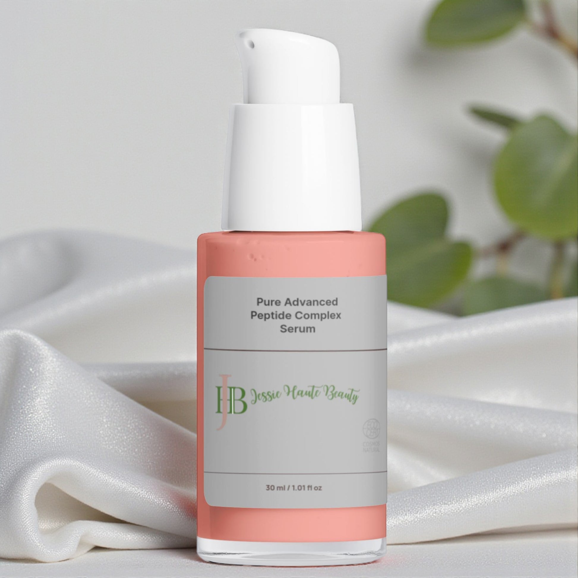 Skincare serum bottle with 'Jesse Marie Beauty' branding on a white fabric background.