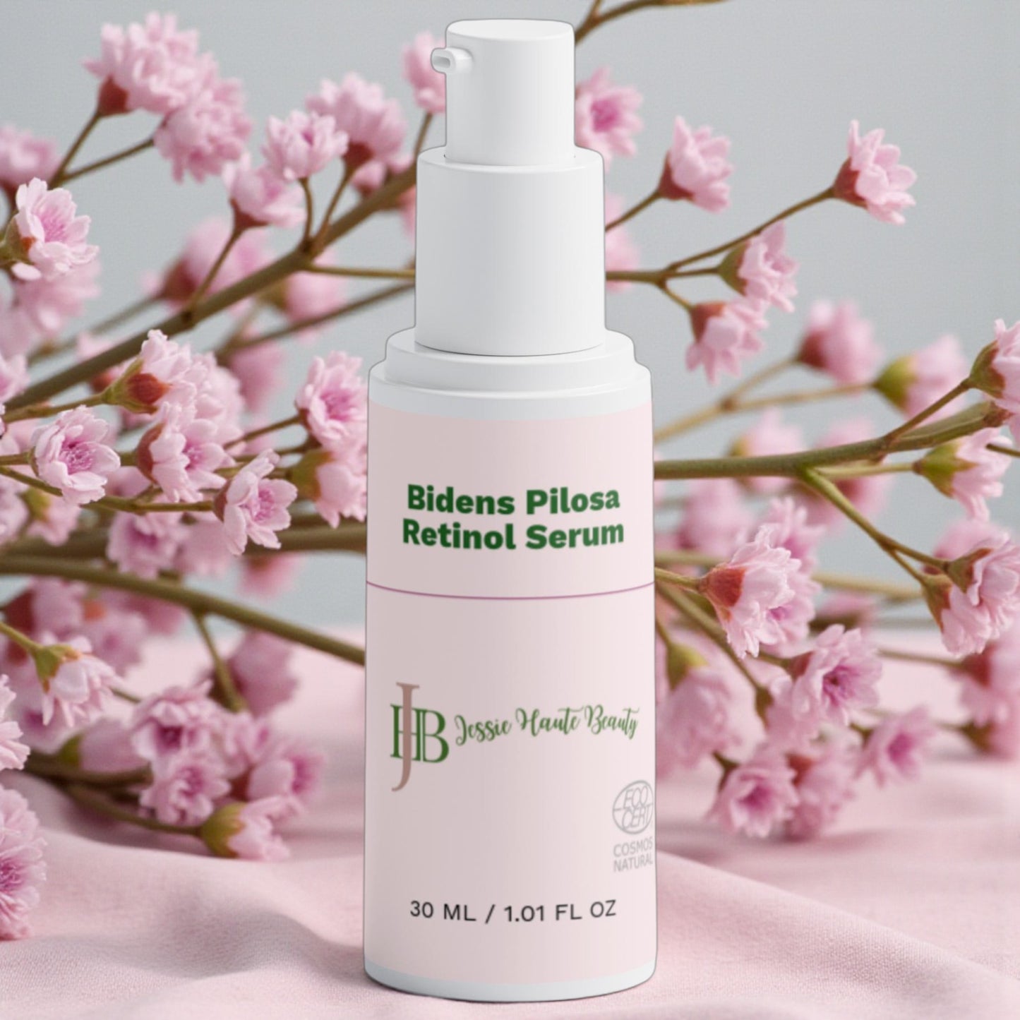 Jessie haute beauty Bidens Pilosa Retinol Serum bottle with pink flowers in the background